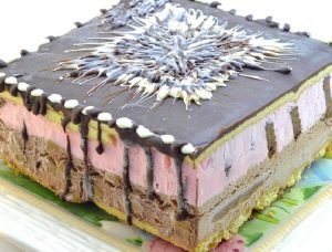 Postre helado de frutillas y chocolate pionono y vainillas